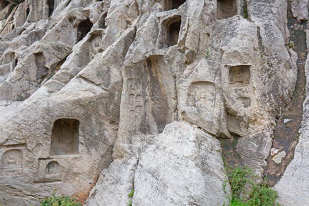 Famous Longmen Grottoes (statues of Buddha and Bodhisattvas carved in the monolith rock near Luoyang in Hennn province, China)の写真素材