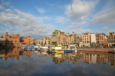 AMSTERDAM - JULY 10: Canals of the Amsterdam city on July 10, 2016 in Amsterdam, Netherlands. The historical canals of the city surrounded by traditional dutch houses is one of the main attractions of Amsterdam.のeditorial素材
