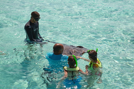 GEORGE TOWN - February 16: Unidentified people visiting Stingray city on Gran Cayman on February 16,...