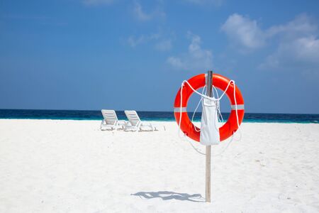 Small island in the Maldives covered by palms and surrounded by turquoise blue waters with with beautiful corals and animals, perfect escape from the cold winterの写真素材