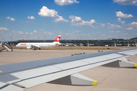 ZURICH - August 10:  Planes preparing for take off at Terminal A of Zurich Airport on August 10, 2018 in Zurich, Switzerland. Zurich airport is home port for Swiss Air and one of the european hubs.のeditorial素材
