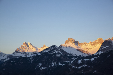 Sunrise over Swiss Alps with snow and glow. Glarusの写真素材
