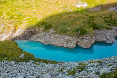 Turquoise Lac Moiry lake with dam in Valais mountains in Switzerlandの写真素材