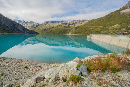 Turquoise Lac Moiry lake with dam in Valais mountains in Switzerlandの写真素材