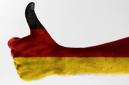 thumb up with digitally body-painted german flag の写真素材