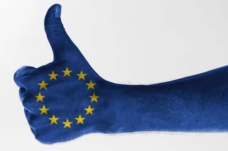 thumb up with digitally body-painted european union flag の写真素材