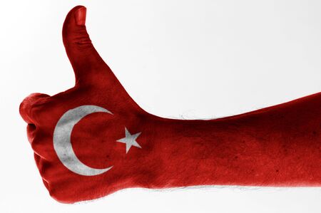 thumb up with digitally body-painted turkish flag の写真素材