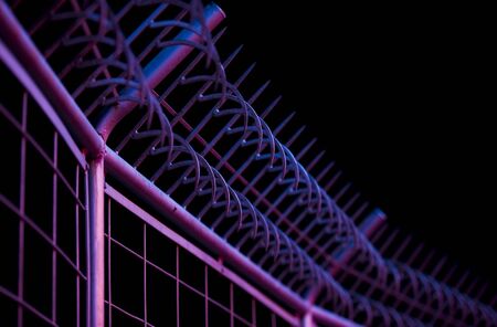 safety bars with hooks with reflected neon lights. photographed with a shallow depth of field.の写真素材