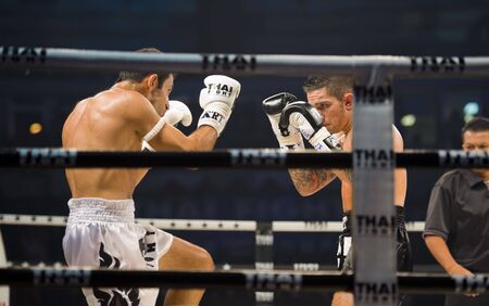 BANGKOK, THAILAND - AUGUST 29, 2010: English thaiboxing world champion Liam Harrison in an international fight competition against Rafighdoust Behzan from Iran.のeditorial素材
