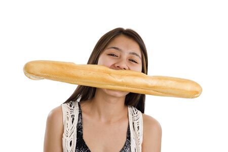 pretty asian woman biting in a french bread, isolated on white backgroundの写真素材