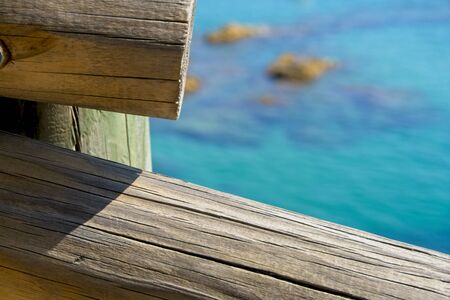 wooden railing with sea view backgroundの写真素材
