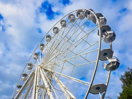 Ferris wheel, in white color with blue sky in the backgroundの写真素材
