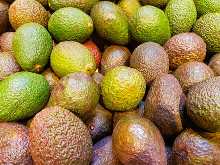 Background with fresh avocado, closeup, selective focus.