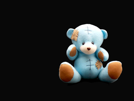Bear doll isolated on blackの写真素材