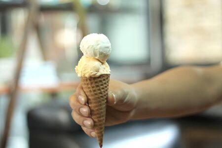 Hand of man holding ice creamの写真素材