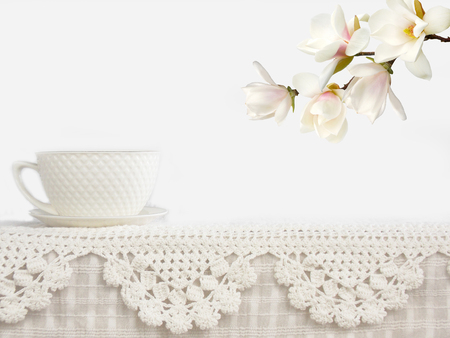 Cup with flower on lace background.の写真素材