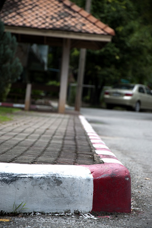 Painting on footpath and the street with red and white color in the cityの写真素材