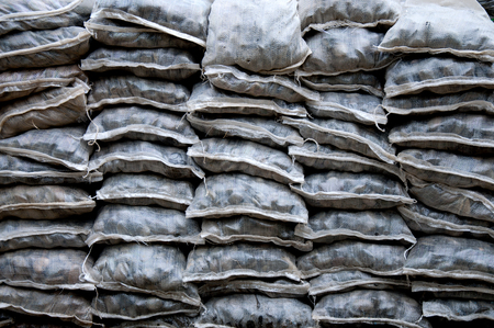 landscaping  with weathered smooth stones in assorted shapes and sizes in bag stackedの写真素材