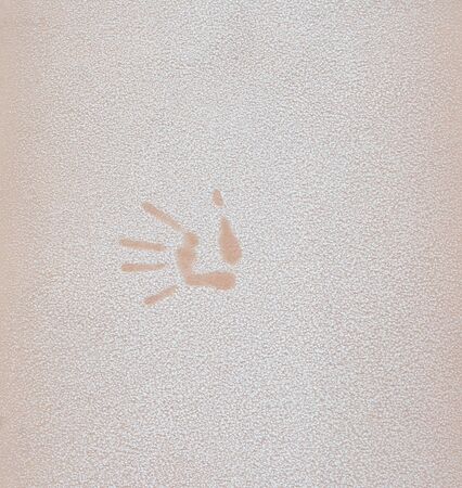 hand print on the orange, beige wall, frostの写真素材