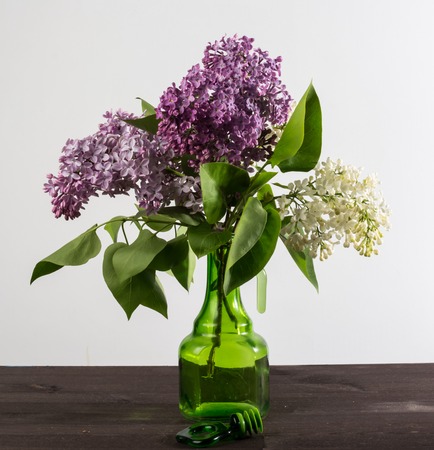 A beautiful bouquet in a vase. A bouquet of lilac branches in a beautiful jar.の写真素材