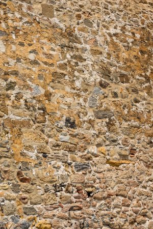 Ancient stone wall of a sea fortress. Masonry of old stones and bricks. Beautiful background.の写真素材