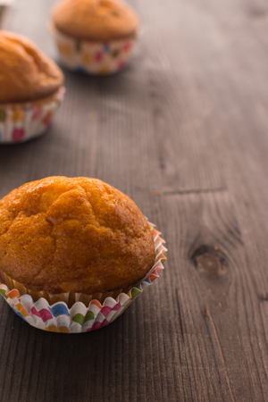 Mafins on a wooden table. Delicious dessert with a blurry background. Festive cupcakes.の写真素材