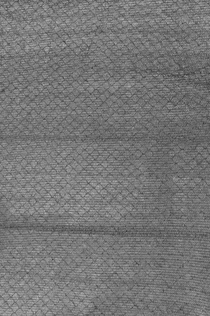 Texture of monophonic tissue, small network. Mesh fabric. Unusual background.の写真素材