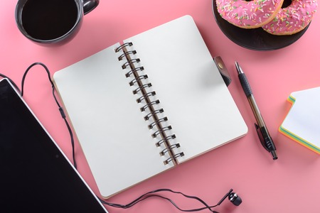 Top view, Open notebook and cup of coffee with donut .の写真素材
