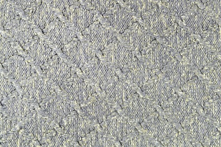 Knitted gray-yellow texture. Beautiful background with patterns in the form of a rhombus of the...