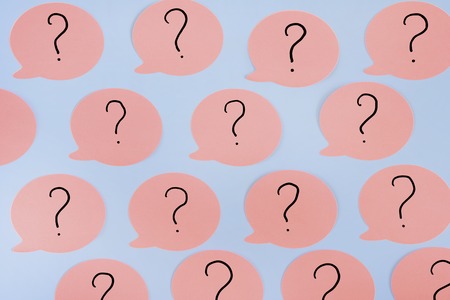 Pink stickers with question marks. Sticky notes on a pink background.の写真素材