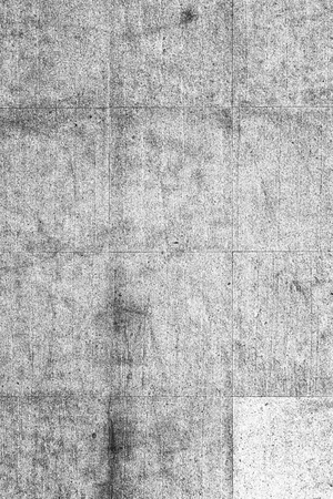 A wall of large stone tiles in gray. The texture of the stone with cracks and scratches.の写真素材