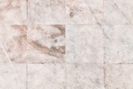 Background with rows of even beige tiles. Texture of old marble close-up.の写真素材