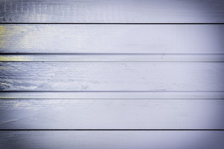 The background of the wooden boards is light purple. Photo with the texture of the tree.