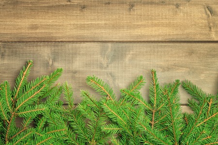 Christmas composition with copy space. Spruce branches neatly laid out bottom of the photo. Festive...