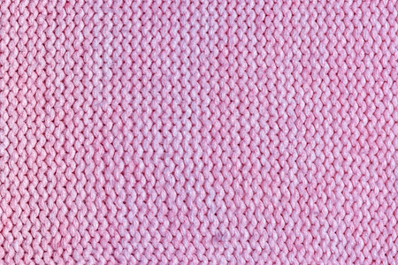 Texture, pink knitted jersey close up. Blank wool background.の写真素材