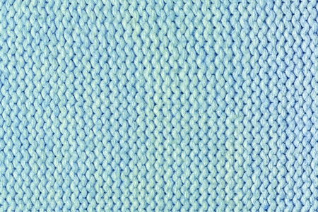 Texture, light turquoise knitted knit close-up. Blank wool background.
