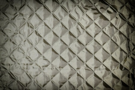 Texture, black quilted fabric close up.の写真素材