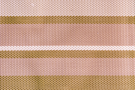 The texture of a large weaving closeup textiles. Abstract background with pale pink and brown stripes.の写真素材