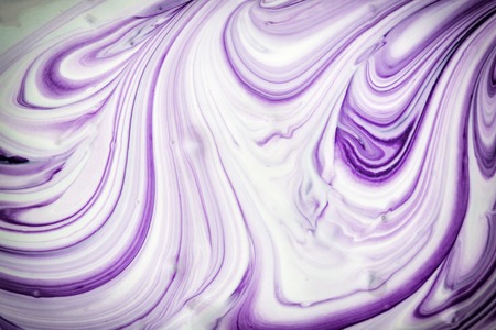 White and dark purple paint mixed up creating a beautiful abstract pattern. Blank background.の写真素材