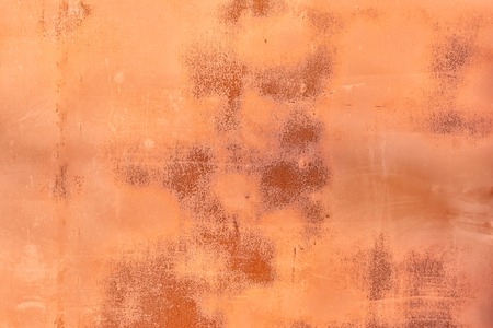 Abstract orange  for layout. Old metal sheet with cracked paint, scratches and rust stains.の写真素材