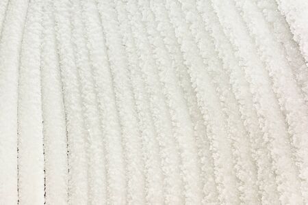 Photo of stripes with crystals of ice closeup.