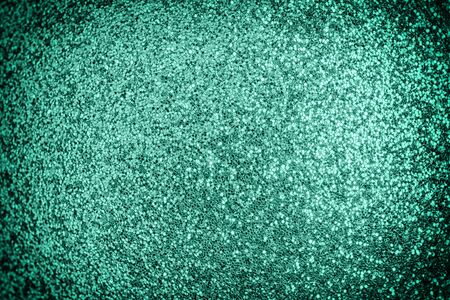 Bright photo of turquoise sparkles with vignette. Festive background for sites and layouts.