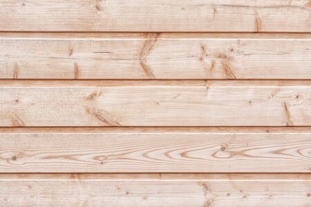 Wooden boards without processing. Fragment of a wooden horizontal fence. Background for the site and layoutsの写真素材