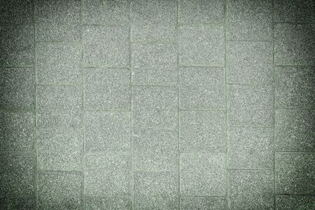 Toned photo of stone paving slabs. Green background with vignette for sites and layouts.の写真素材