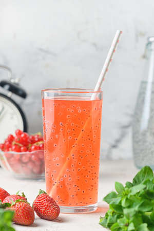 A glass of refreshing strawberry and red currant compote. A healthy drink with basil seeds. Super food.の写真素材