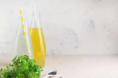 Two bottles with refreshing compote from berries and basil seedsの写真素材