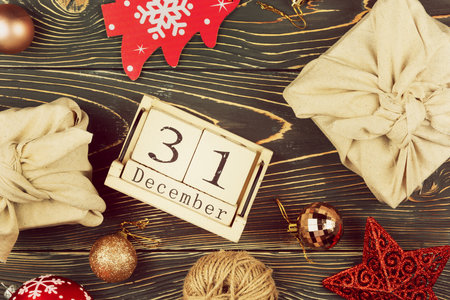 Christmas composition on a wooden background. Gifts wrapped in cloth, Zero Waste.の写真素材