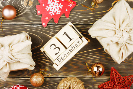 Christmas composition with a perpetual calendar. Gifts wrapped in cloth, Christmas balls and decorationsの写真素材