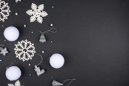 White Christmas decorations lie on a black background. Copy space. Christmas card mockupの写真素材