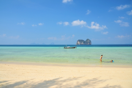 A couple in the crystal clear sea with white sand beach, Thailandのeditorial素材